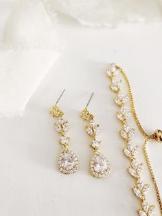 This stunning earrings and bracelet set will add the perfect touch of sparkle and elegance to your wedding or special event outfit! Made with high quality materials, these CZ earrings will be sure to impress in person and in photographs.... i n f o  +  d e t a i l s ...Made of AAA quality Cubic Zirconia stonesAvailable in Gold plated metalPush on backings included3.5 cm long earrings15-21 cm around bracelet*Due to hygienic reasons, no returns or exchanges permitted on hair accessories or earring Gold Diamond Drop Earrings, Jewelry Set Gold, Bridal Statement Earrings, Bride Jewelry Set, Crystal Earrings Wedding, Diamond Wedding Jewelry, Wedding Jewelry Set, Gold Bridal Earrings, Bride Jewelry