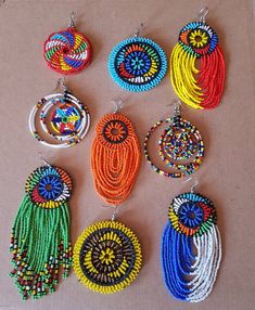 ALL my items are shipped through Dhl Express** This listing is for ALL 9 pairs. The earrings are 100% handmade using original fine beads. *A combination of hoops and tassels. You cant resist. Colorful and bright colors that will make you stand out from the rest. The set makes a perfect gift to loved ones, reselling or for personal use. Buy multiple items and pay shipping for ONE item ONLY. Hoop Beaded Earrings, Shotgun Shell Crafts, Flower Jewelry Designs, Large Silver Hoop Earrings, Wholesale Earrings, African Earrings, Multicolor Earrings, African Trade Beads, Store Ideas