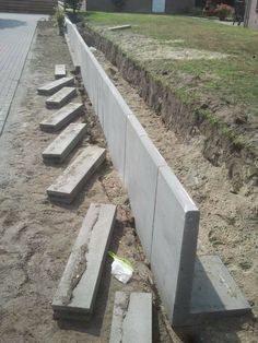 concrete steps are lined up along the side of a road in front of a house