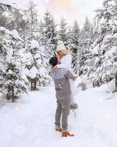 a woman carrying a child in the snow