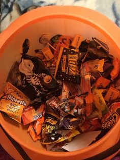 an orange bowl filled with halloween candy