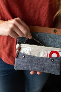 a woman is holding an empty wallet in her hands