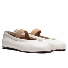 The Tabi Elastic Band Mule in Ivory/Nude, made from lamb leather, features the distinctive Tabi split-toe design and an elastic band for a comfortable fit. These mules are crafted with attention to detail, including handmade folds and subtle branding with the Maison Margiela logo on the sole. Made in Italy, they are a blend of traditional style and modern craftsmanship. 100% Lamb leather upper, lining, and interior 100% Calf leather sole Distressed elastic band, Tabi split toe Handmade leather f Spring Gala Calf Leather Flats, White Leather Slip-on Flats, White Leather Pointed Toe Ballet Flats, Beige Leather Ballet Flats For Spring, Classic White Leather Ballet Flats, White Fitted Flats With Round Toe, Cream Slip-on Flats With Removable Insole, Beige Leather Ballet Flats Medium Width, Cream Leather Slip-on Flats