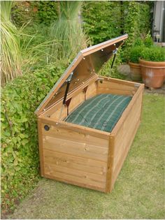 an open wooden box sitting in the grass