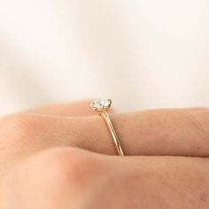 0.25ct brilliant cut diamond, 4mm, near colorless, eye clean 0.50ct GIA certified Excellent cut grade G color SI1 clarity (Made to order) Band width: approx. 1.1mm to 1.4mm tapered band High profile four prongs flower setting Made of 100% recycled solid 14k yellow gold and ethically sourced gemstone Alice ring is minimal and dainty, features 0.25ct brilliant cut diamond in our signature flower setting. The tapered band adds elegance to this unique engagement ring. The diamond size and quality ca Dainty Marquise Cut Ring With Single Diamond, Dainty Emerald Cut Diamond Wedding Ring, Minimalist Lab Grown Diamond Jewelry, Wedding Stackable Diamond Rings With Single Diamond, Minimalist Emerald Cut Diamond Ring With Single Cut Diamonds, Minimalist Rose Gold Diamond Wedding Ring, Dainty Lab-grown Diamond Rings, Minimalist Asscher-cut Diamond Ring For Anniversary, Minimalist Single Cut Diamond Ring For Anniversary