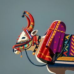 a colorfully decorated cow kite flying in the sky