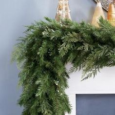 a christmas wreath is hanging on the mantle