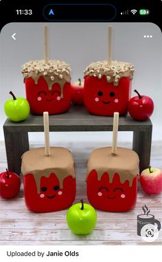 some apples are sitting on a table with cupcakes