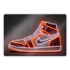 a pair of sneakers is lit up with neon lights in the shape of a shoe