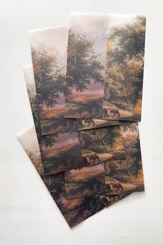 four pieces of art depicting horses grazing in a wooded area with trees on the other side