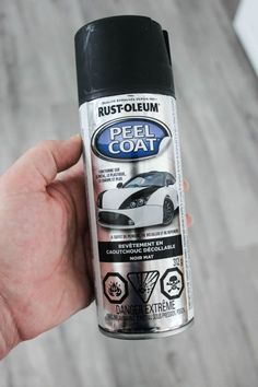 a hand holding a spray can of rust - oleum peel coat