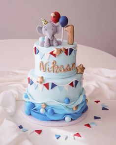 a blue cake with an elephant on top