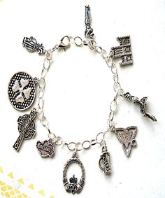 This charm bracelet features Irish inspired Tibetan silver charms(nickel free). The charms are attached to a silver tone 7.5 inches chain bracelet with lobster clasp closure. Symbolic Charm Bracelet With Dangling Charms, Symbolic Silver Bracelets With Dangling Charms, Silver Symbolic Bracelets With Dangling Charms, Symbolic Silver Bracelet With Dangling Charms, Symbolic Dangle Charm Bracelet, Symbolic Metal Charm Bracelet With Dangling Charms, Silver Symbolic Charm Bracelet Hypoallergenic, Symbolic Silver Hypoallergenic Charm Bracelet, Symbolic Sterling Silver Charm Bracelet With Lobster Clasp