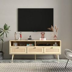 a living room with an entertainment center in the middle and a large blackboard above it