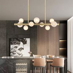 a modern kitchen with marble counter tops and bar stools