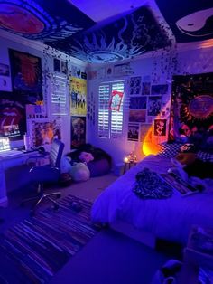 the bedroom is lit up with purple lights and posters on the walls, along with other decorations