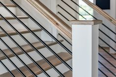 a close up view of some stairs and railings with wood handrails in the foreground