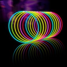 neon colored circles are arranged in the dark