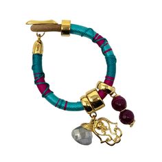 Meet our candy-look bracelet with a gold pleated San Benito charm. Wear it by itself or many together, they look fantastic. 8 inches long. Clay Bracelet, Camera Straps, Black Clay, Beautiful Handbags, Crystal Charm, Green Turquoise, Blue Bracelet, Capital City, Ethnic Wear