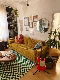 a living room filled with lots of furniture and decor on top of a hard wood floor