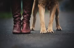 two dogs standing next to each other with their feet on top of the dog's leg