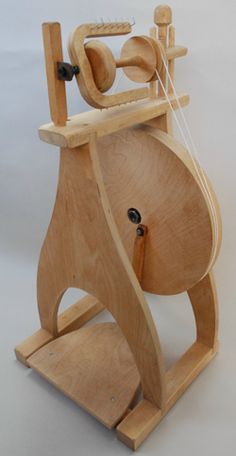 a wooden spinning machine on a white background with strings attached to it's sides