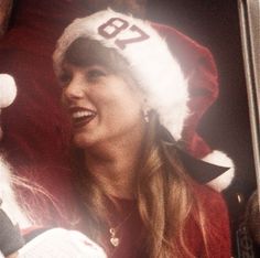 a woman wearing a santa hat and holding a baby