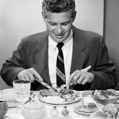 a man sitting at a table eating food