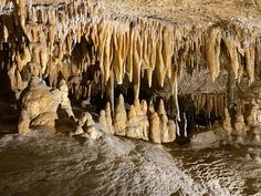 the inside of a cave with stalate formations hanging from it's ceiling