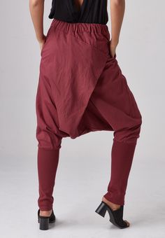 "🚚..ALL ORDERS ARE SHIPPED VIA DHL EXPRESS MAIL Relaxed fit dropped-crotch pants in red. Asymmetric crossover fabric panel at front and back with 3 buttons front detailed. Elastic waistband and two hand pockets at side seam. Roll up the cuffed hem for an utlra relaxed look! * Pull-on style * Drop-crotch style * 2\" Elastic waistband * Side seam pockets * Wide cuffed hem Measurements approximately: Waist : 26\" (66 cm) stretching to 48\" (122 cm)-elastic material Hips : 50\" (122 cm) Outseam: 38 Red Cotton Harem Pants For Fall, Baggy Red Harem Pants With Pockets, Red Baggy Harem Pants With Pockets, Burgundy Cotton Wide Leg Pants, High Waist Red Harem Pants With Pockets, Red High-waist Harem Pants With Pockets, Red High Waist Harem Pants With Pockets, Red Loosely Fitted Cotton Harem Pants, Red Baggy Trousers