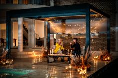 two people sitting at a table with candles in front of them