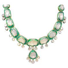 This stunning, one-of-a-kind Polki necklace is absolutely incredible. Bursting with sparkle from the sizeable diamonds, this piece also features bold color and a unique custom design. A single elegant row of uncut diamonds (H-J / SI-I1) bezel set in 18 karat yellow gold lay on top of squared, bright green glass links. Dangling off each green section are additional diamonds in a pear shaped setting. The diamonds dangle gently, adding sparkle and movement to the unique piece. An additional diamond Uncut Diamond Necklace, Polki Necklace, Uncut Diamond, Bold Color, Green Necklace, Diamond Cluster, Custom Necklace, White Enamel, Green And Gold