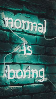 a neon sign that says normal is boring