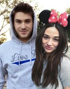 a man and woman wearing minnie mouse ears