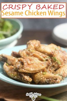 crispy baked sesame chicken wings on a blue plate with lettuce in the background