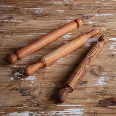 three wooden rolling pins on a wood surface