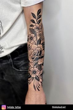 a man with a flower tattoo on his arm