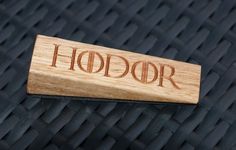 a wooden business card holder with the word hodor engraved on it's side