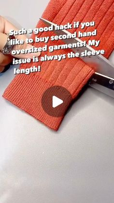 someone cutting fabric with a pair of scissors on top of the cloth that is being cut