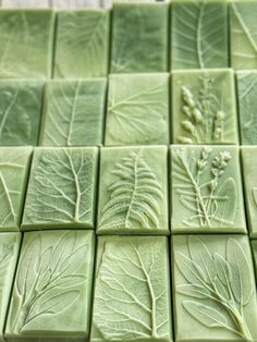 green tiles with leaves and flowers on them