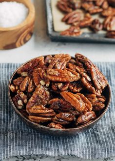 a bowl full of pecans sitting on top of a table