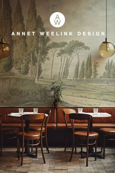 an empty restaurant with tables and chairs in front of a wall mural that reads, annet welkin design