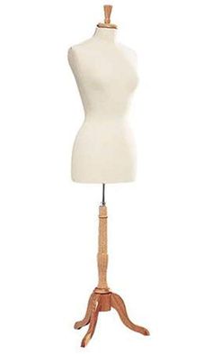 a white mannequin on a wooden stand