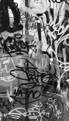 black and white photograph of graffiti on a wall