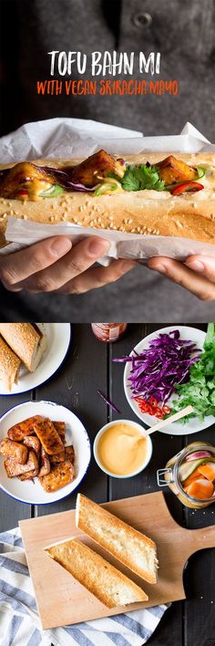 a person holding a sub sandwich with veggies and sauces on the side