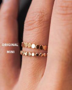 A timeless ring that comes in two distinct styles to suit your taste - the Original style and the all-new Mini style. This MINI version of the Bead Ring has enhanced sturdiness while maintaining the distinctive design that sets our signature Bead Ring apart.  This listing is for ONE SINGLE ring in the style of your choice! This ring is made out of 14K GOLD FILL, ROSE GOLD FILL or STERLING SILVER. The finish is lightly faceted/hammered. Choose between the ORIGINAL BEAD or MINI BEAD RING. SPOT THE Delicate Rose Gold Minimalist Midi Rings, Dainty Circle Midi Rings For Everyday, Dainty Midi Rings With Simple Design, Dainty Stackable Circle Rings As Gift, Dainty Circle Stackable Rings As Gift, Minimalist 14k Gold Filled Stackable Rings, Minimalist Stackable 14k Gold Filled Rings, Minimalist Stackable Round Midi Rings, 14k Gold Dainty Midi Rings