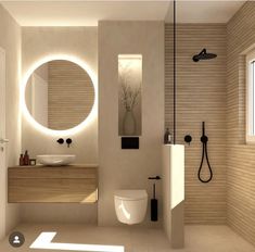 a bathroom with a sink, toilet and shower in it's center wall is illuminated by round mirrors