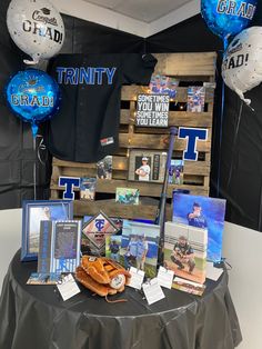 a table topped with baseball memorabilia and balloons