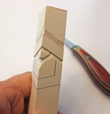 a hand holding a small piece of cardboard