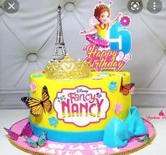 a birthday cake with the eiffel tower in the background